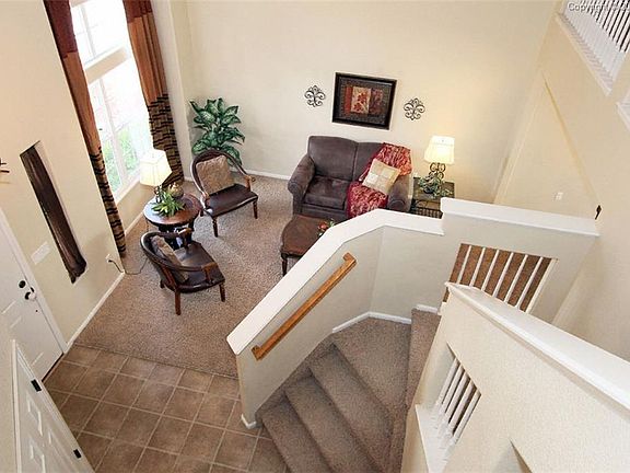 Foyer and living room with large windows that brighten the home