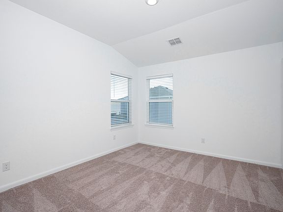 Master bedroom with multiple windows that make the space feel bright and open.