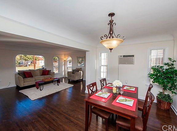 Living room leads to dining room with chandelier