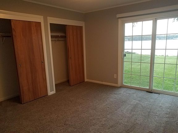 Bedroom with sliding door to backyard. Great view of lake...