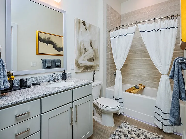 Modern bathrooms include framed mirrors, garden soaking tubs and double vanities in select homes