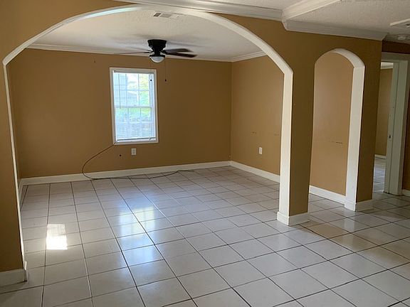 View from dining area looking into entry way area and living room. View of one bedroom.