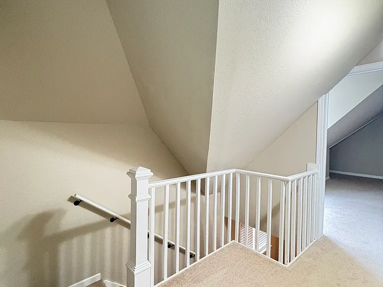 The top of the stairs offers space for a chair and side table, creating the perfect spot to enjoy a morning mug of your favorite hot beverage from the coffee/tea station.
