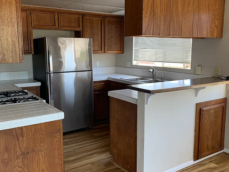 Kitchen with large capacity frig, dishwasher, and gas cooktop and oven.