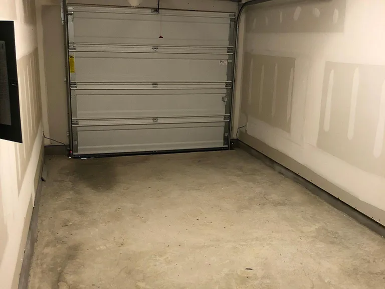 Private attached garage, space for car and garbage bins