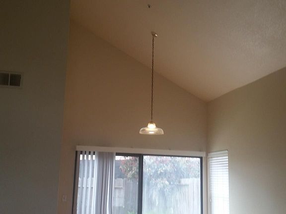 Vaulted ceiling in first level, laminate flooring. Sliding door leads to large patio deck and fenced backyard for relaxing.