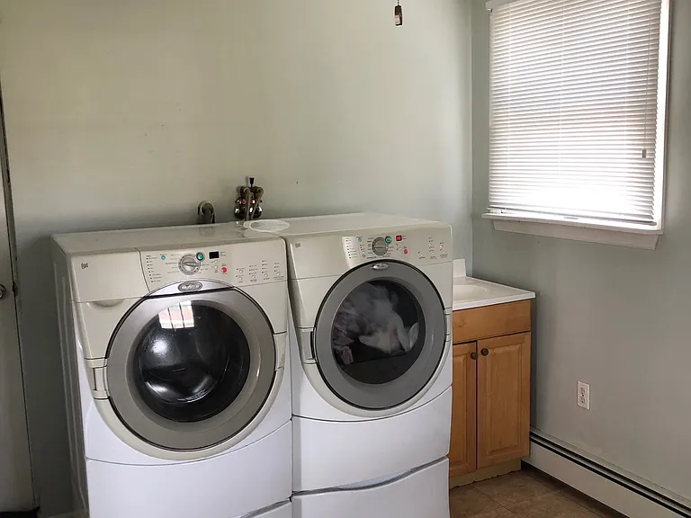 separate laundry room on main level with plenty of space for shelving units on the other walls to also function as a walk-in pantry