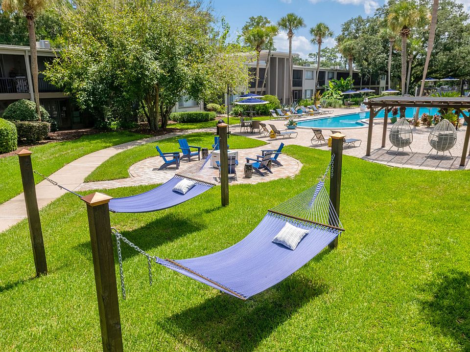 Revel in elegant outdoor amenities like the blissful hammock garden, vivacious fire pit, and vibrant resort-style pool.