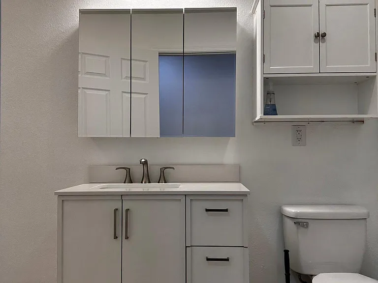 Newly installed vanity and freshly painted. The bathroom has washer and dryer already installed and a bathtub- shower.