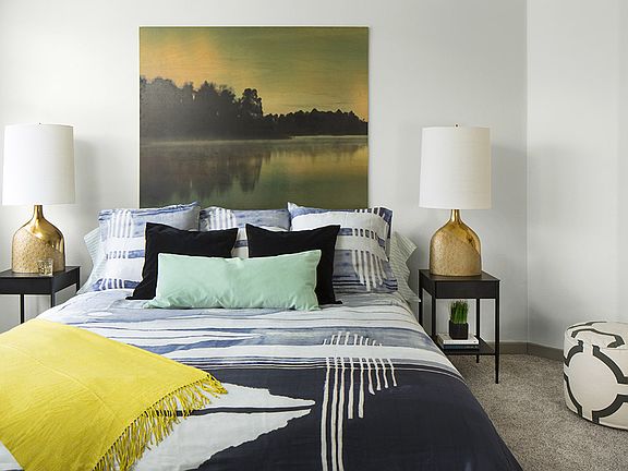 Spacious apartment bedroom with carpeted floors.