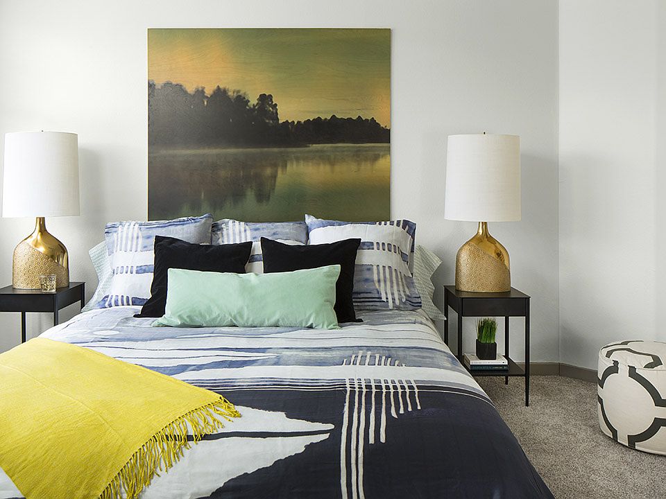 Spacious apartment bedroom with carpeted floors.