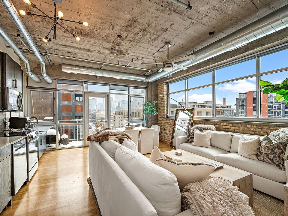 View of the kitchen, living room, and dining from the hallway.