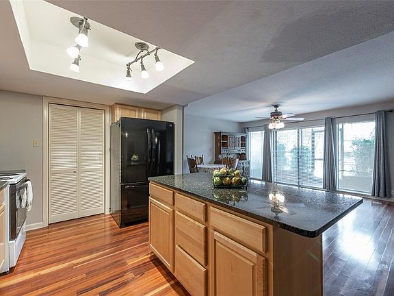 From foyer, walking into the kitchen. Pantry and washer/dryer (included) behind folding doors. Refrigerator included.