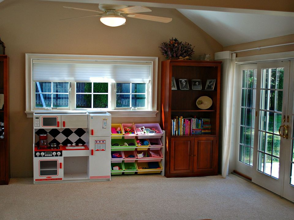Sunroom/playroom with vaulted ceilings, ceiling fan, and wide French door walk