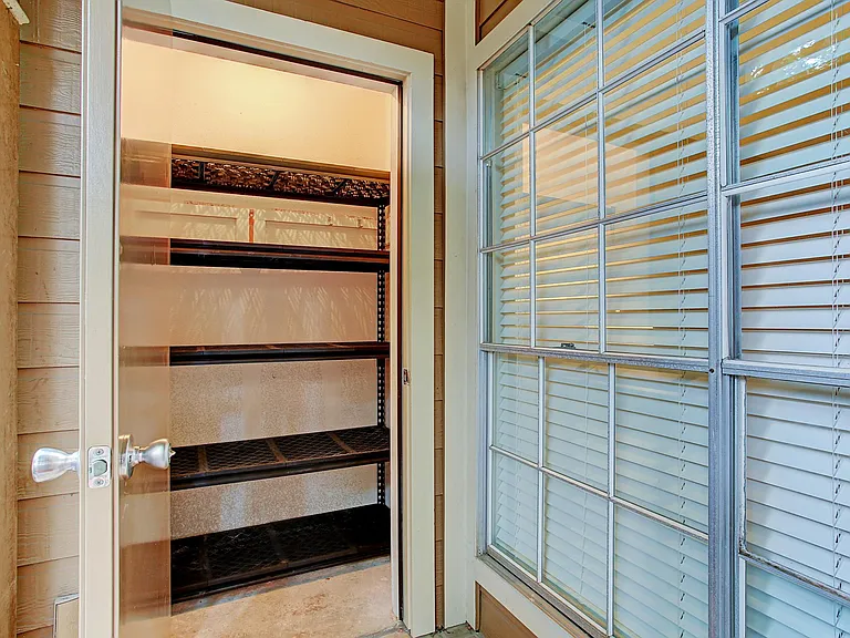 Roomy outdoor storage closet with shelves.