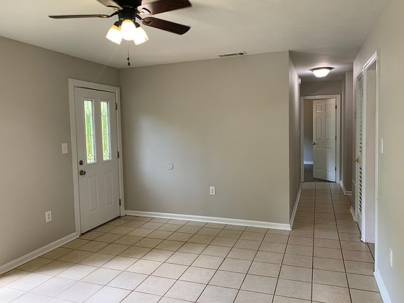 Front room connects to hallway to three bedrooms.