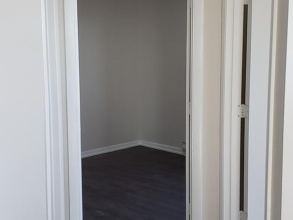 Looking into the back bedroom, front bedroom on the right, bathroom to the left