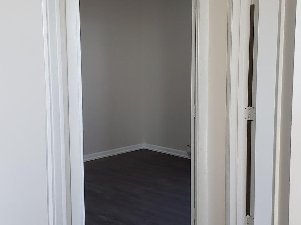 Looking into the back bedroom, front bedroom on the right, bathroom to the left