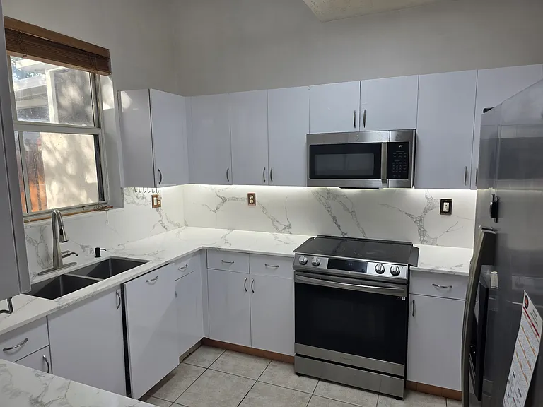 Kitchen - new counter top & backsplash with undercabinet led lights & touch less faucet. Wifi connected smart Range