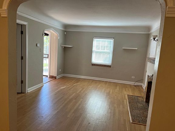 View of living room and front entry from dining room