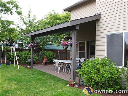 Large covered patio at rear looking west