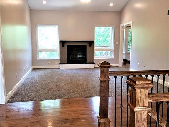 Great room with direct vent fireplace, new tile surround, new carpet and paint.