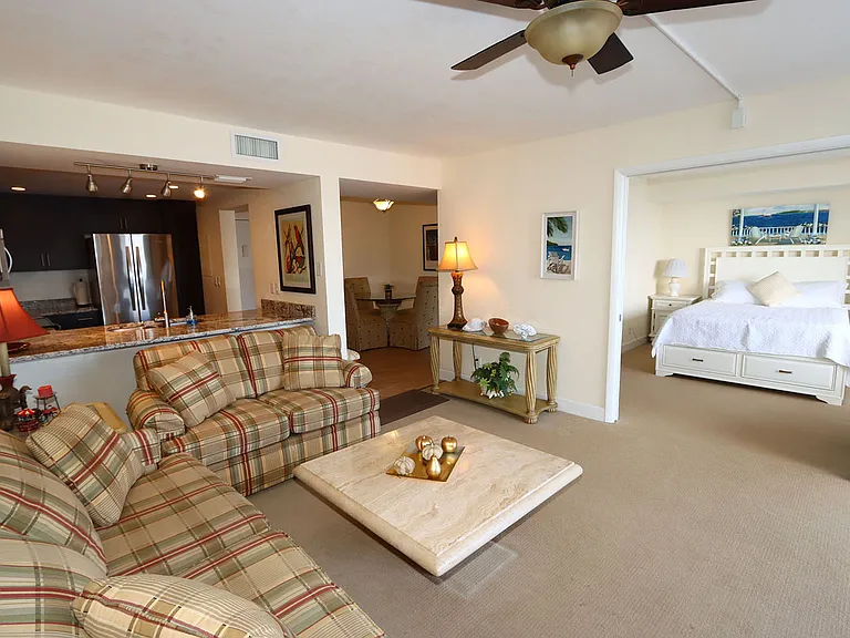 Living Room with view of kitchen pass through and 2nd bedroom with open door.