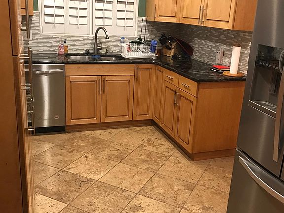 Updated kitchen travertine floor tile backsplash all stainless steel newer appliances