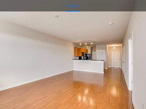 View of living room into kitchen (looking towards front door)