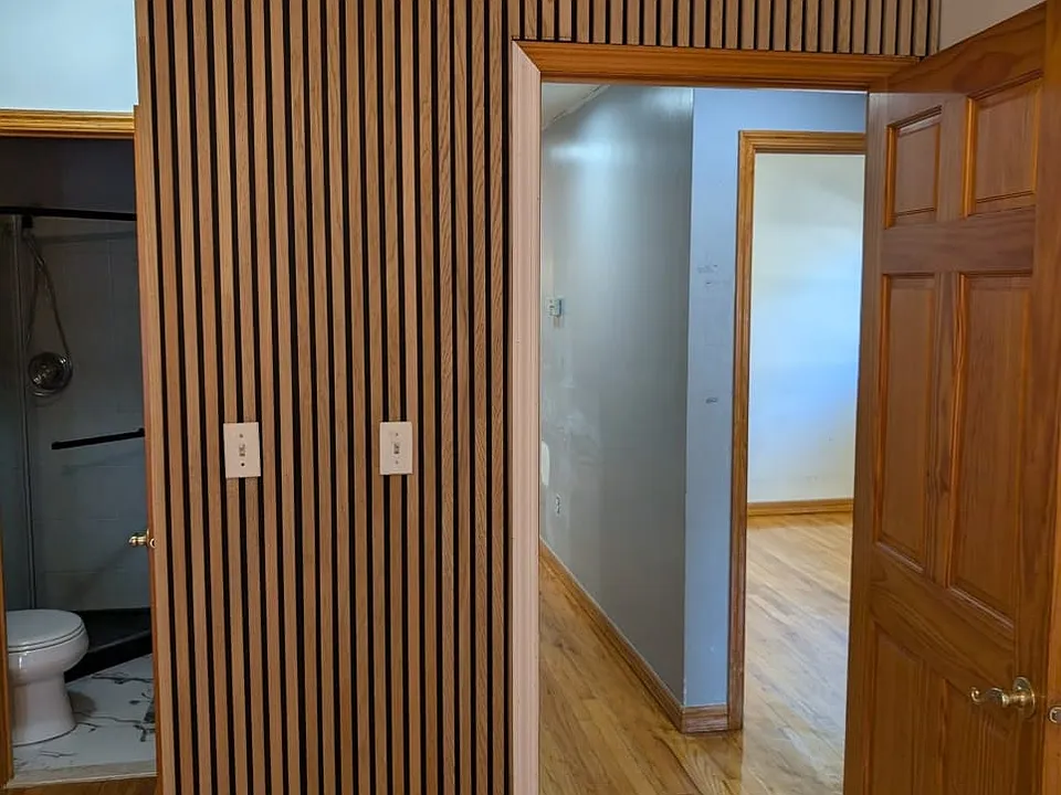 Master bedroom with wood wall panel accent wall