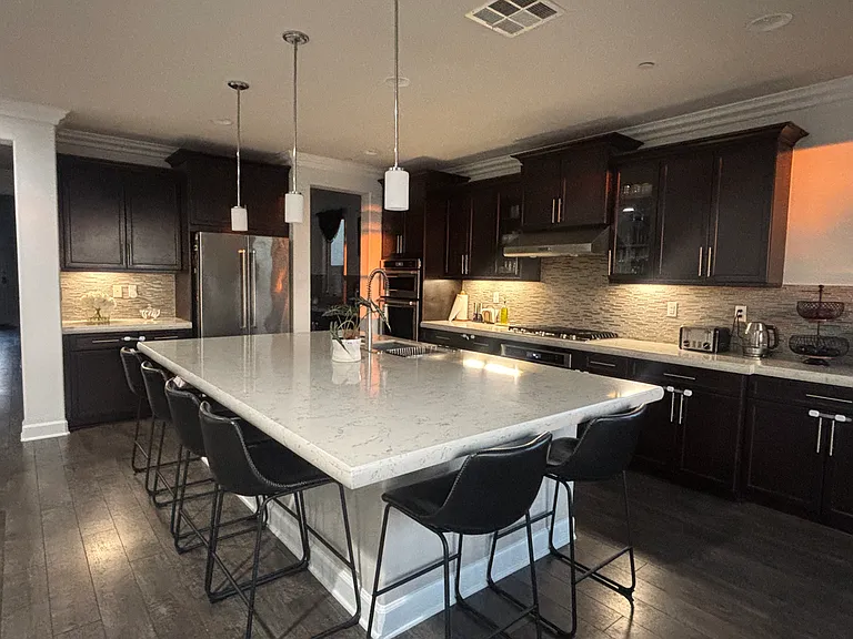 double countertop with bar seating for 6; double dishwashers, high end kitchen-aid appliances