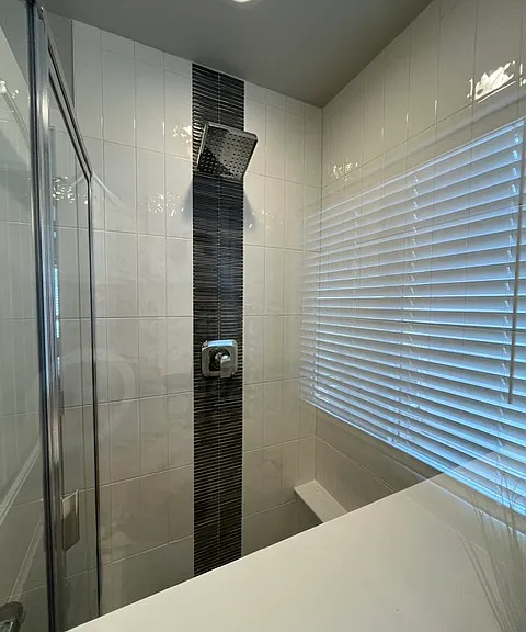 Separate shower with custom tile and shelves for your items