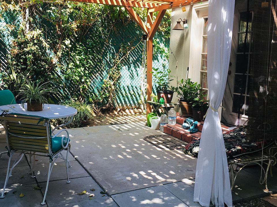 Private Patio with Trellis, wrought iron table & chairs, and lights.