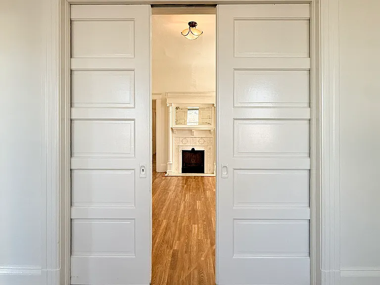 looking from front living room through pocket doors to inner living room
