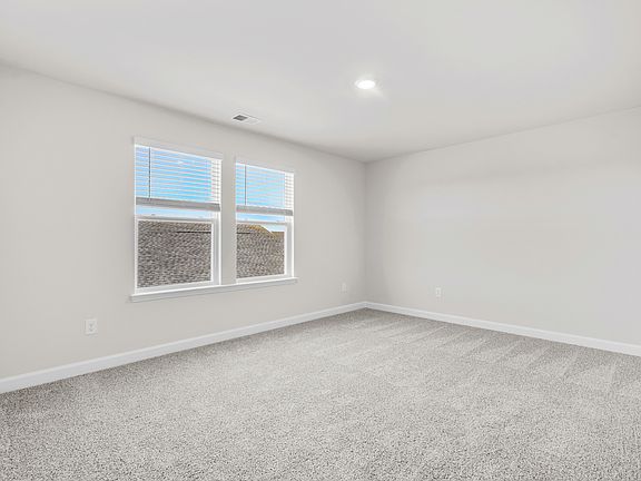 A private bedroom is located upstairs off of the loft.