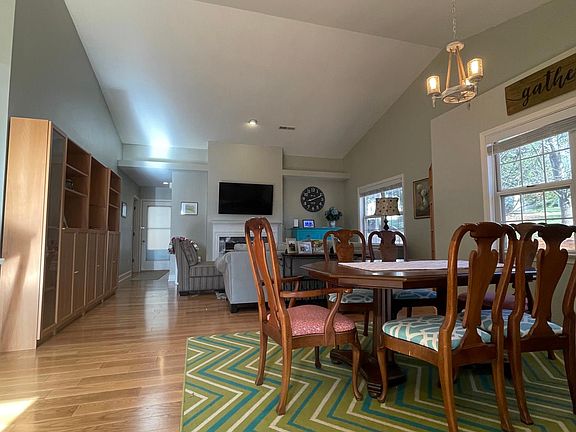 Dining and a living areas with fireplace and vaulted ceiling ski