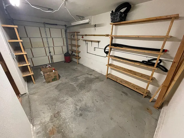 3rd garage bay with storage. (Electric door opener installed but not pictured)