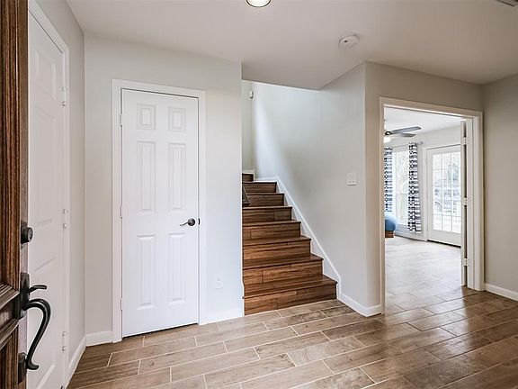 The entryway and first floor bedroom have had recent hardwood look tile installed.