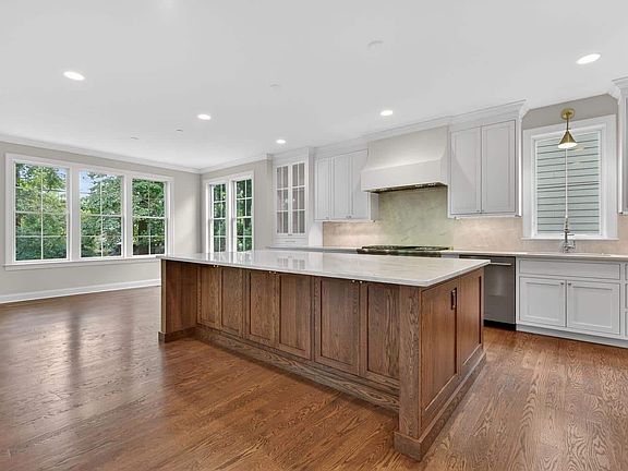 Cabinetry wraps the perimeter, island centers it all