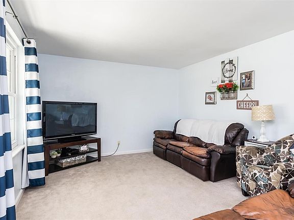 Family room freshly painted w/ ample amounts of natural light