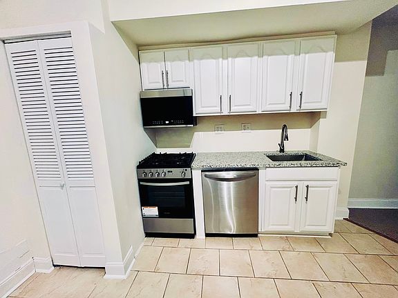 Kitchen has stainless steel appliances and granite countertops.