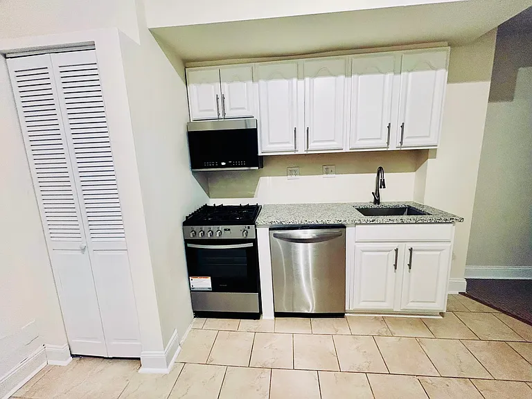 Kitchen has stainless steel appliances and granite countertops.