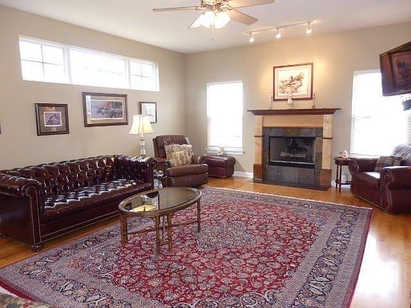Large living room with gas fireplace.  Mounted TV stays.