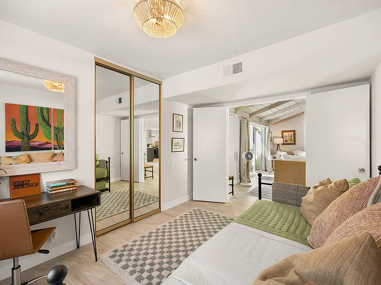 Guest room with twin trundle bed, working desk and ample closet space.