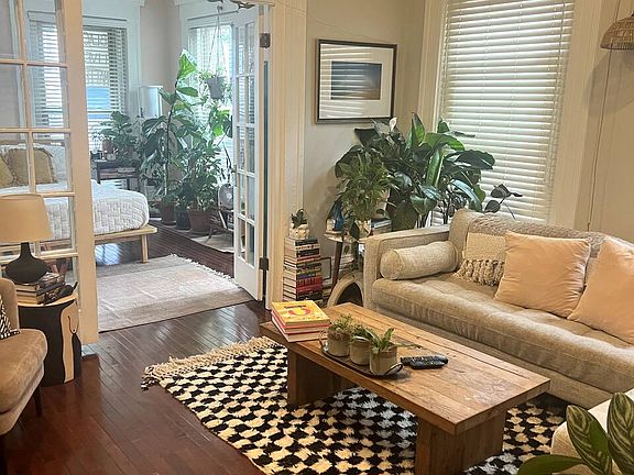 Living room receives lots of light. French doors open up to large bedroom.