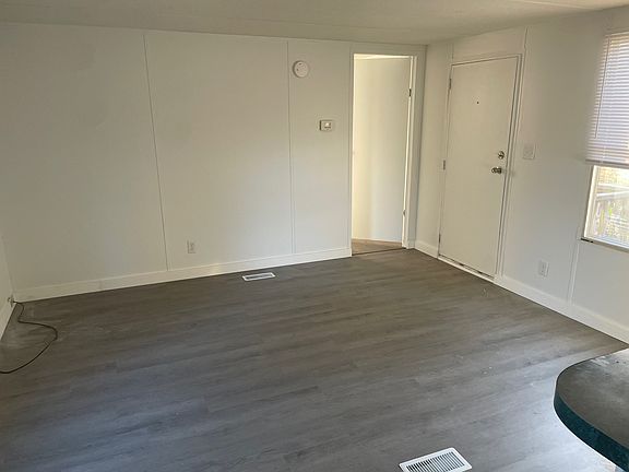 Living room. That is the "front" door, but parking space leads to "back door", which enters at kitchen area.