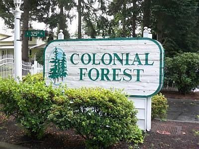 Main entrance to the gated Colonial Forest Condominiums.