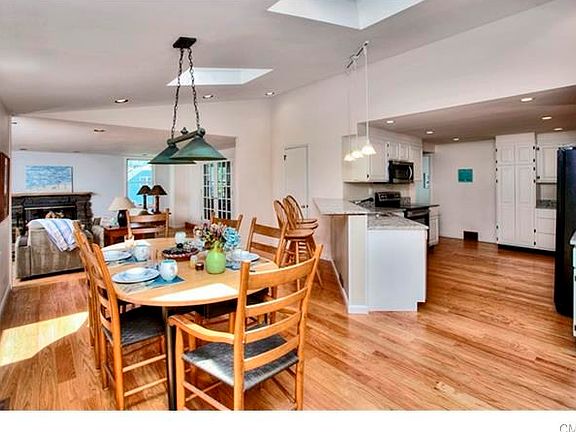 White Cabinets with new granite countertops looking from the Breakfast area to the Family Room with FPL.