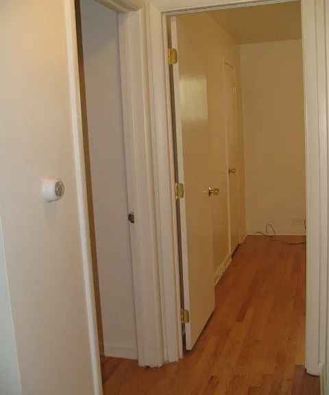 Hallway from the living room; bedroom1 on the left, bedroom2 straight ahead AND bathroom to the right