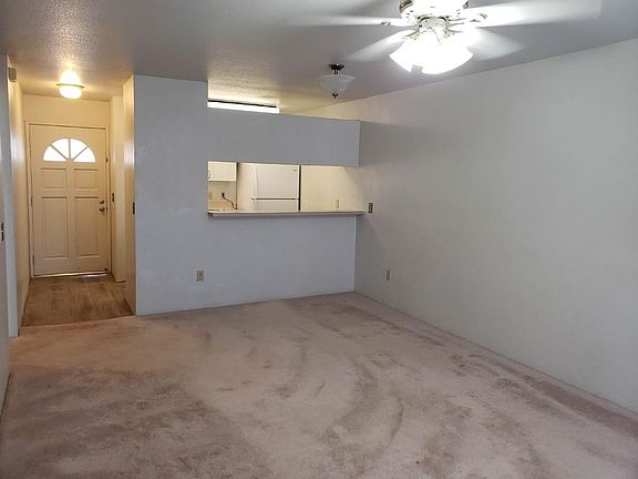 Living room with ceiling fan and A/C